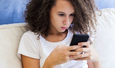 teen girl looking at phone