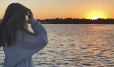 Teen girl looking at sunset