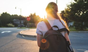 teen girl walking to busstop