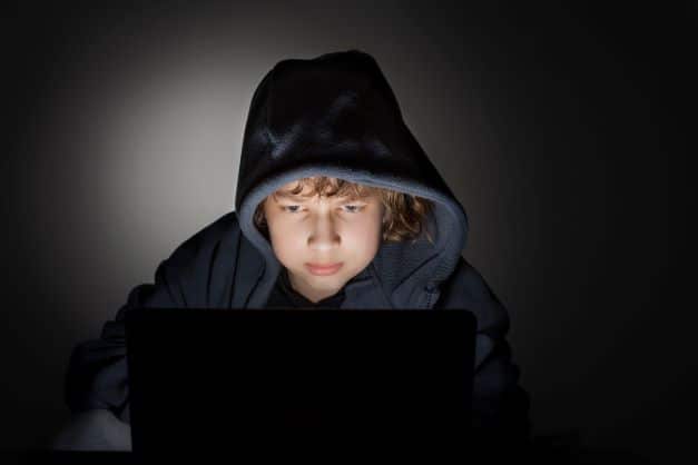 teen boy looking at computer